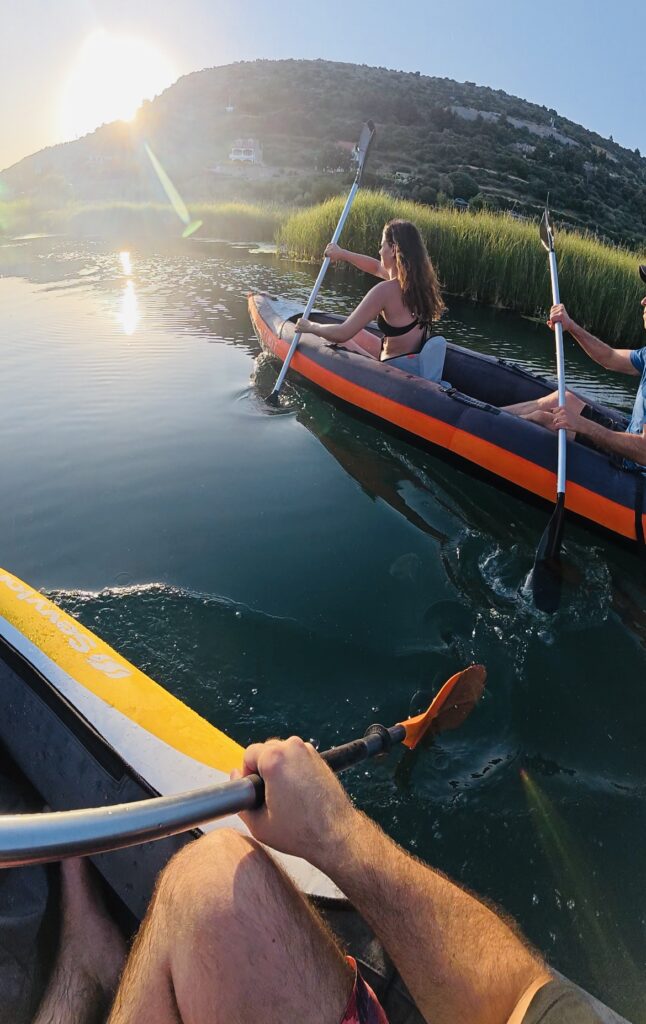 a group of people in kayaks on a lake